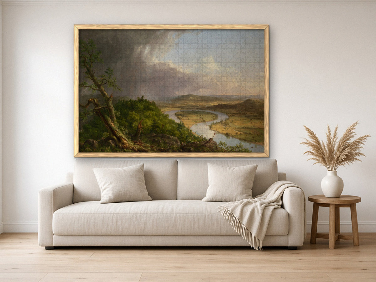 After the Storm Passed 1014 piece puzzle assembled, framed in light wood and hung above a cream sofa, with pampas grass on a side table