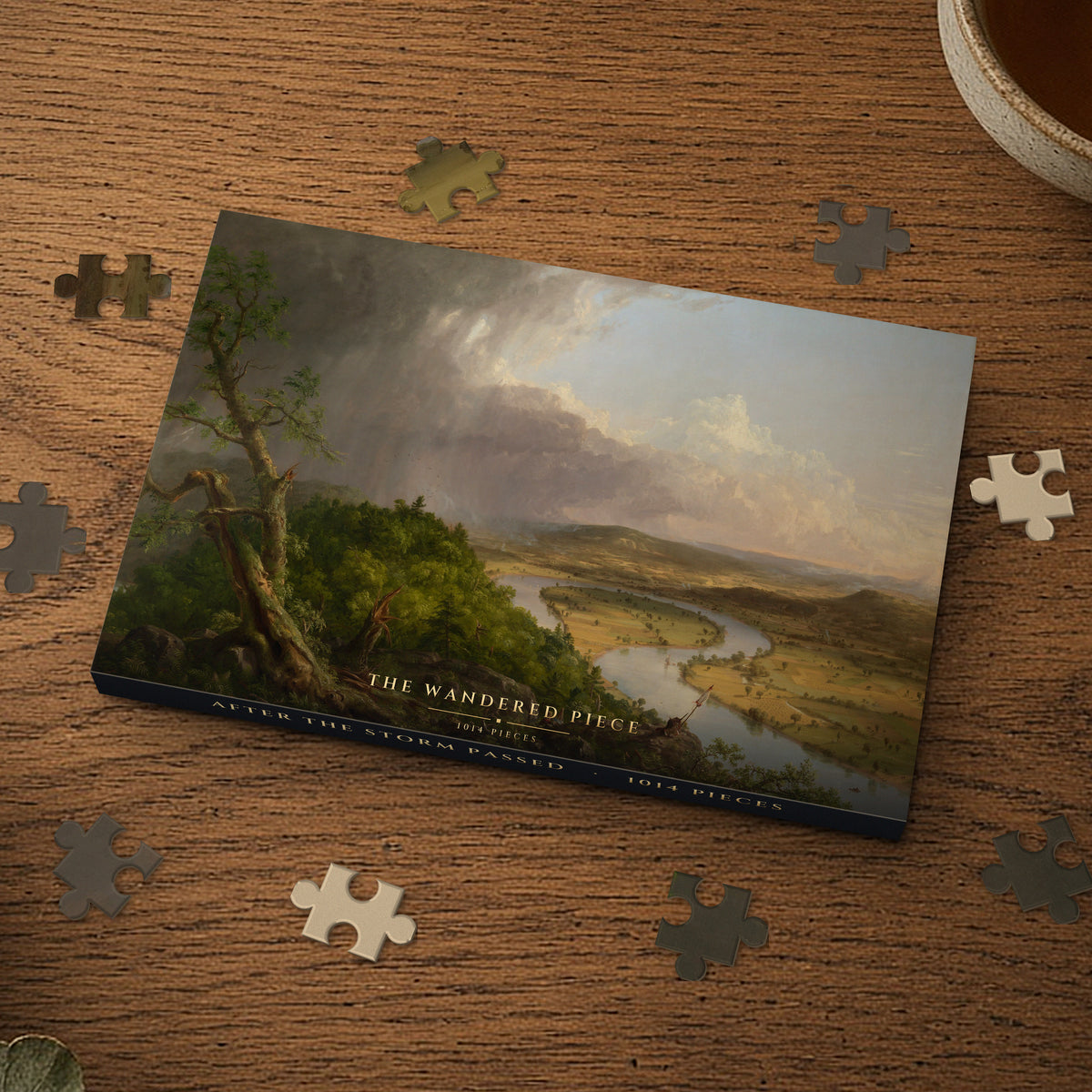 After the Storm Passed 1014 piece puzzle box on a wood table with loose pieces, box design shown for illustration