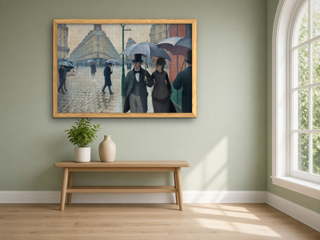Paris, Just After Rain 1014 piece puzzle assembled, framed in light wood on a sage green wall above a wooden bench, next to a tall arched window