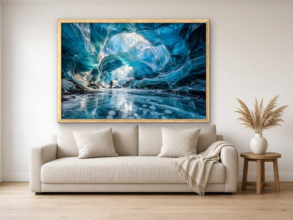 The Cave Where the Ice Glows Blue 1014 piece puzzle assembled, framed in light wood and hung above a cream sofa, with pampas grass on a side table