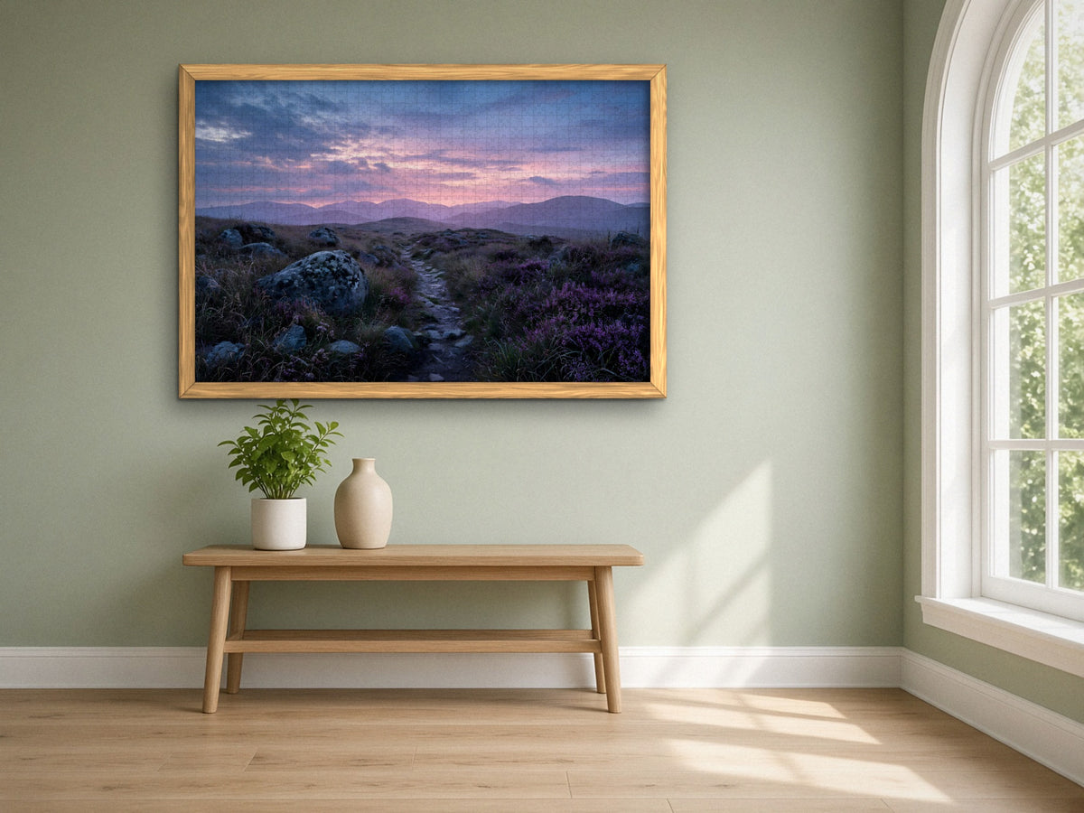 The Heather Road Home 1014 piece puzzle assembled, framed in light wood on a sage green wall above a wooden bench, next to a tall arched window