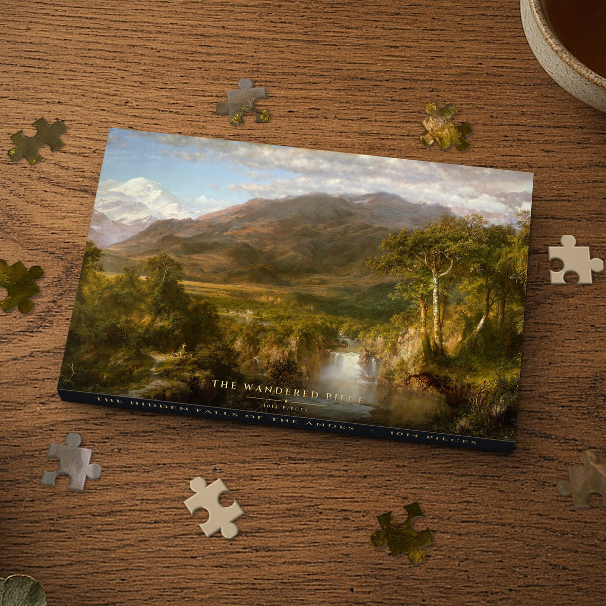 The Hidden Falls of the Andes 1014 piece puzzle box on a wood table with loose pieces, box design shown for illustration