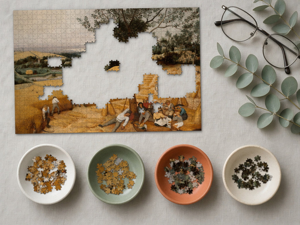 The Long Gold Afternoon 1014 piece puzzle partly assembled on a linen cloth, loose pieces sorted into four small ceramic bowls beside reading glasses and eucalyptus