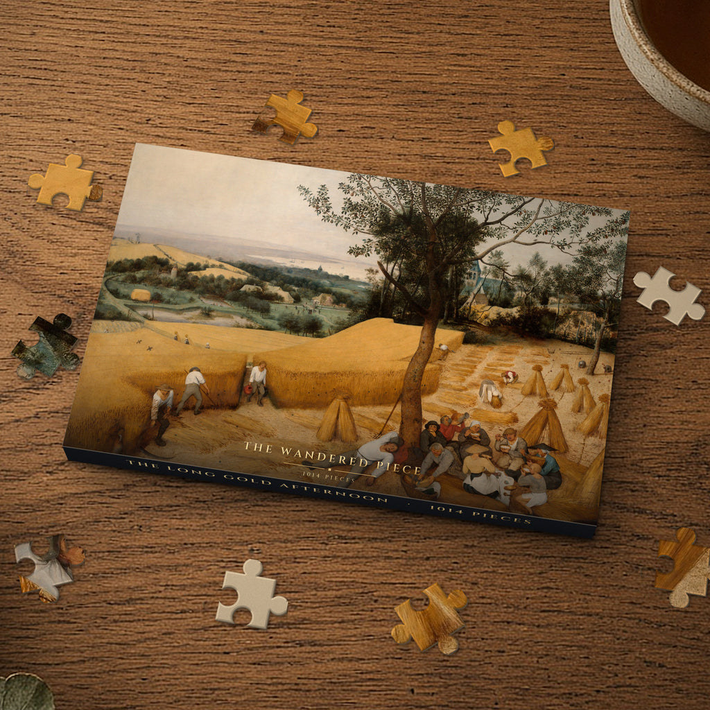 The Long Gold Afternoon 1014 piece puzzle box on a wood table with loose pieces, box design shown for illustration