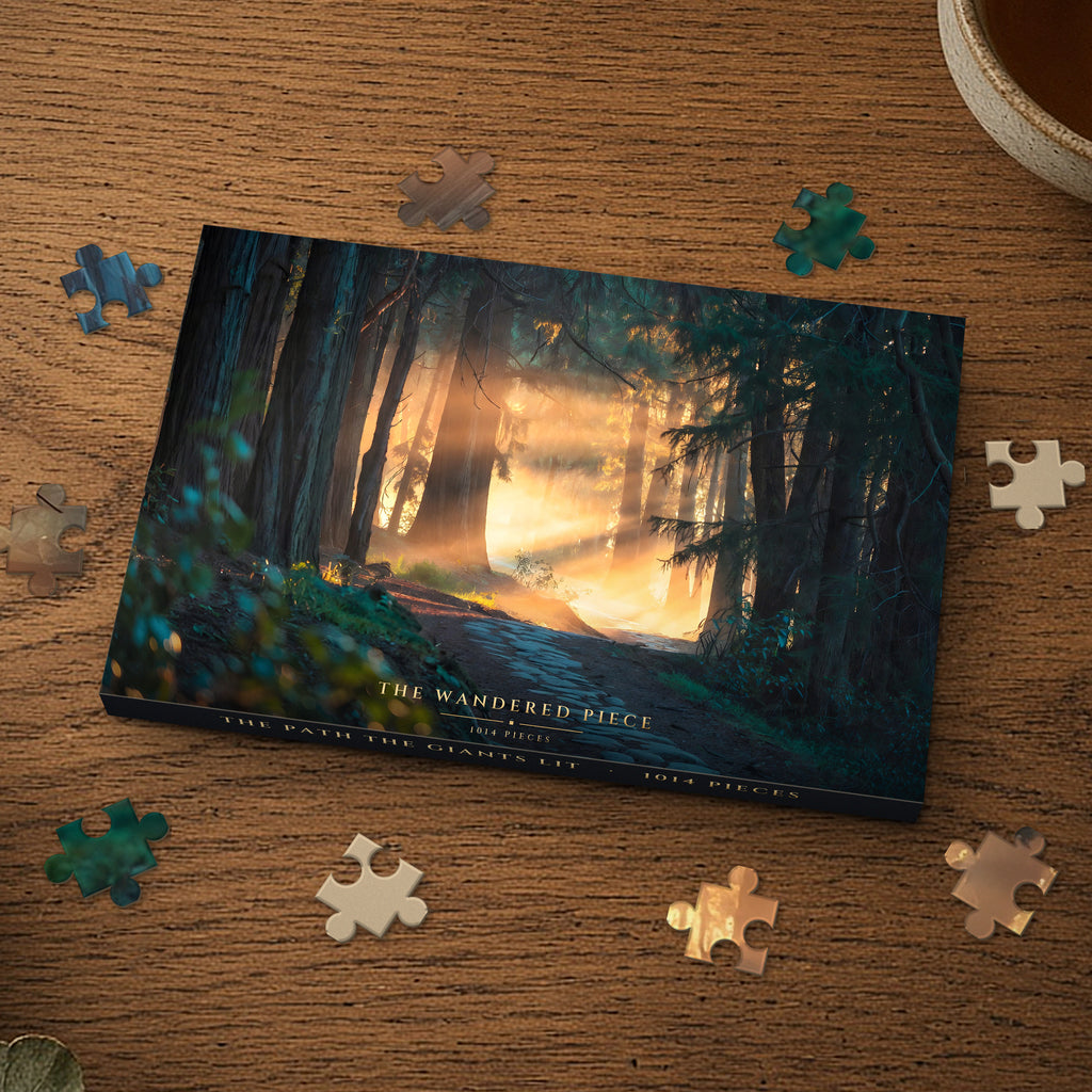 The Path the Giants Lit 1014 piece puzzle box on a wood table with loose pieces, box design shown for illustration