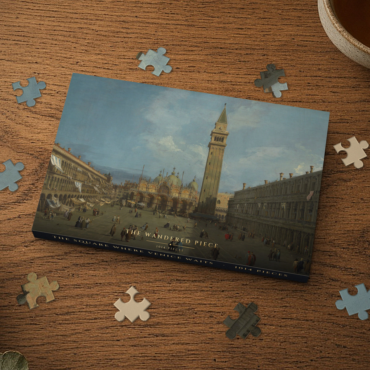 The Square Where Venice Waits 1014 piece puzzle box on a wood table with loose pieces, box design shown for illustration