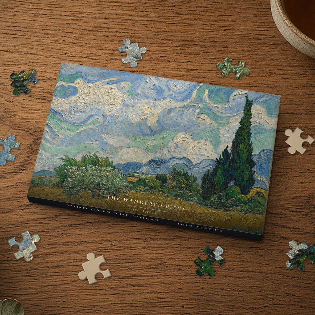 Wind Over the Wheat 1014 piece puzzle box on a wood table with loose pieces, box design shown for illustration